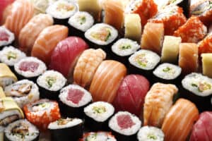 many tasty fresh japanese sushi with white rise red tuna caviar orange shrimp
