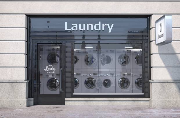 A local brick-and-mortar laundromat is open and with a good amount of washing machines inside waiting for use.